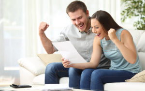 Couple Excited looking at paper