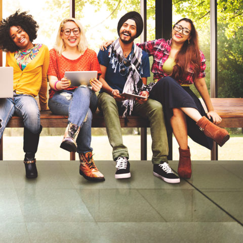 smiling diverse group of men and women sitting together