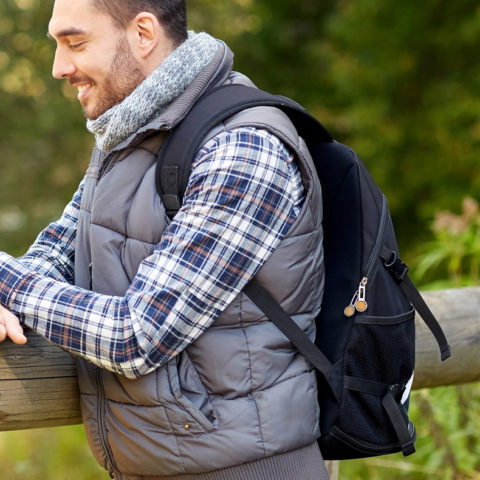 Man hiking and using cell phone
