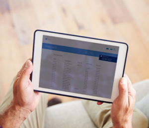 Man reviewing statement on tablet