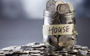 Jar of coins with label "house."