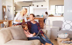 Family on a laptop sitting on the couch