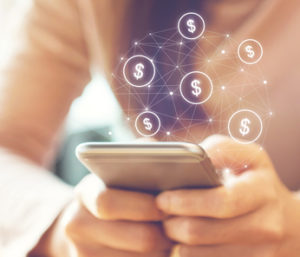 Girl holds cell phone in her hand. Dollar signs are floating above it.