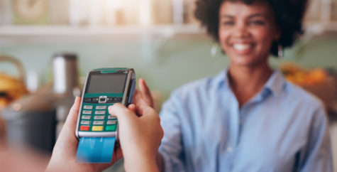 Young lady paying for shopping with her card