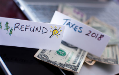 Taxes 2018 Refund sheet of paper with money in the background