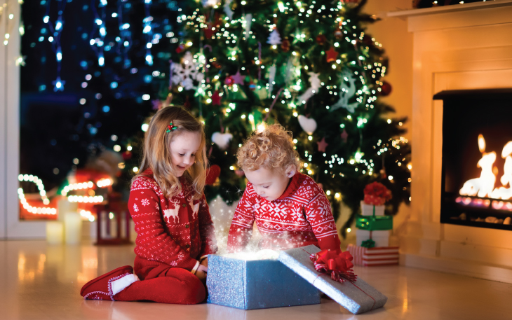 Young children opening Christmas gifts