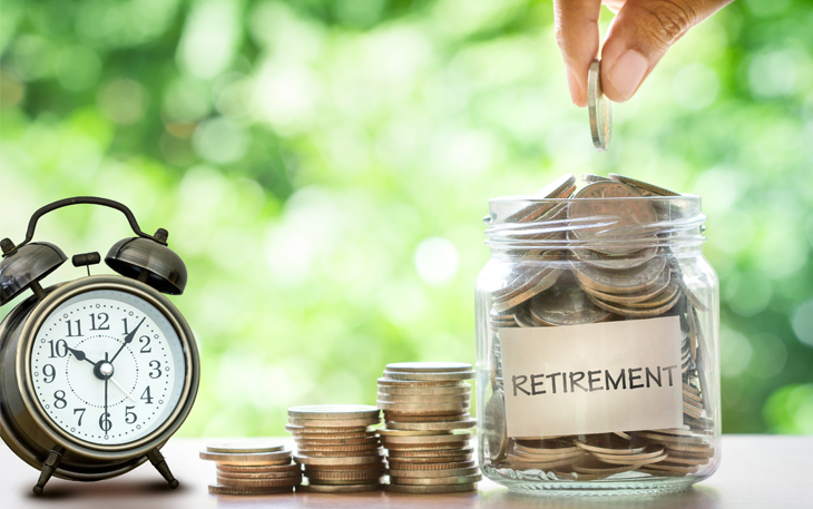 A person puts a quarter into a jar of coins with the word "retirement" on it. There is a stack of coins next to it with a clock.