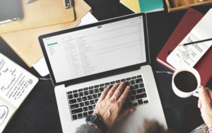 Man's hand working at a computer