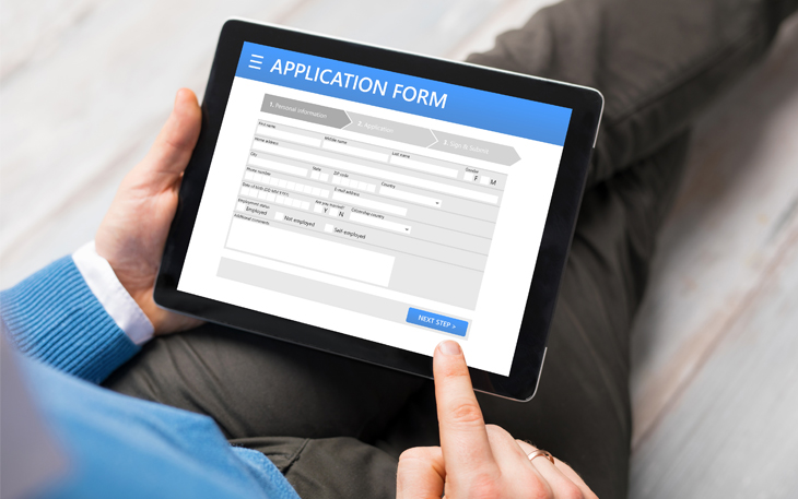 Man uses his tablet to fill out a job application