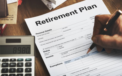 Close up photo of a calculator and form that says "retirement plan."