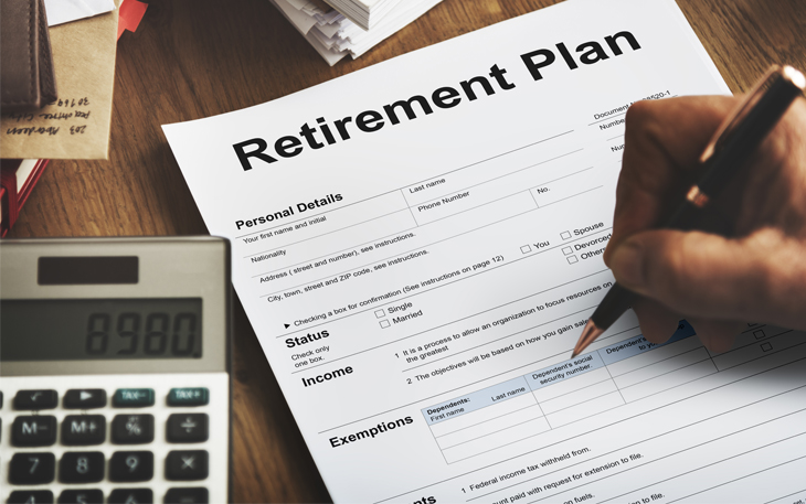 Close up photo of a calculator and form that says "retirement plan."