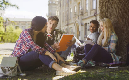 Group of college students study outside.