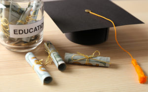 Education money with graduation cap