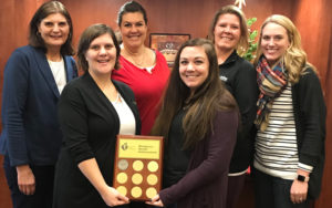 Member of SouthPoint's Wellness Committee takes their photo with their American Heart Association Award