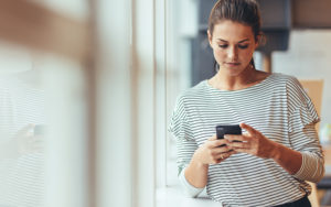 Lady reviewing her paystub on her cell phone