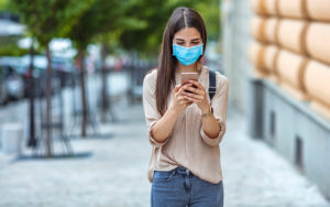 Lady looking at her cell phone while walking