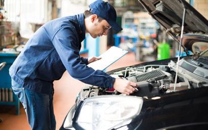 Mechanic looking over car