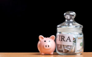 Piggy Bank next to jar of money that says IRA