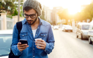 Man looking at his cell phone while outside