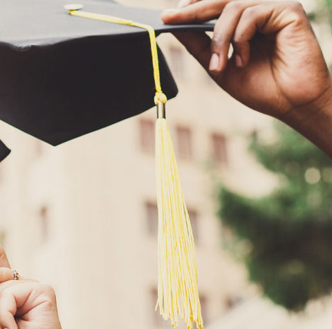 Graduation mortar boards being thrown in air