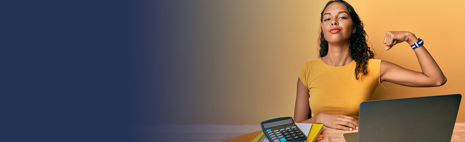 Woman flexing arm in front of computer and calculator