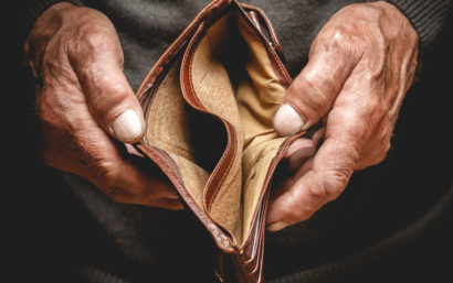 Empty wallet in the hands of an elderly man.