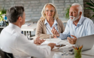 Mature couple sits in front of a financial advisor.