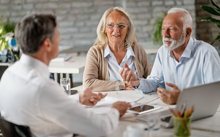 Mature couple sits in front of a financial advisor.