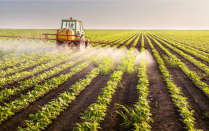 Farmer tends field in machinery.